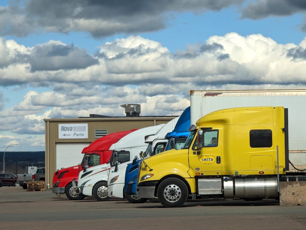 Parked semi-trucks of various colors outside a Nova Parts warehouse in Truro, NS.
